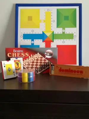 a dresser with a box of dominoes and other toys on it at Apto Melkart in Chiclana de la Frontera