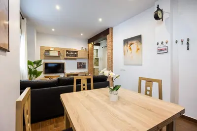 a living room with a table and a couch at Casa Plotina Pompeya in Cádiz