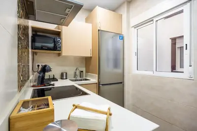 a small kitchen with a sink and a refrigerator at Casa Plotina Pompeya in Cádiz