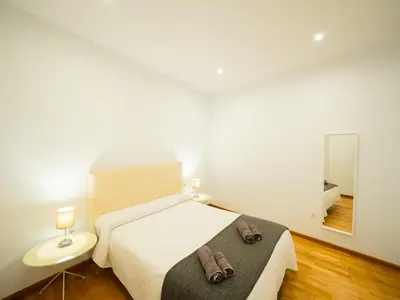 a bedroom with a bed with two shoes on it at Amplio Apto Centro vistas Torneria fjhomefj in Jerez de la Frontera