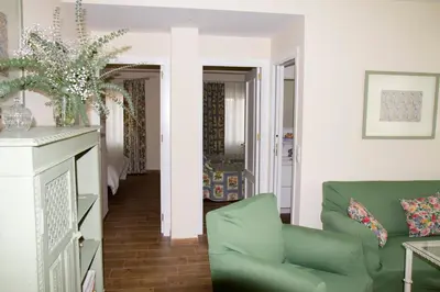 a living room with a couch and a chair at Infanta Beatriz in Sanlúcar de Barrameda