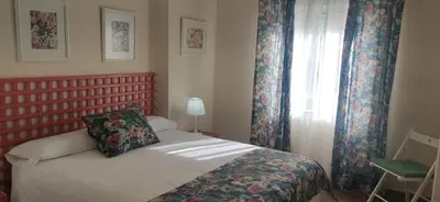 a small bedroom with a bed and a window at Infanta Beatriz in Sanlúcar de Barrameda