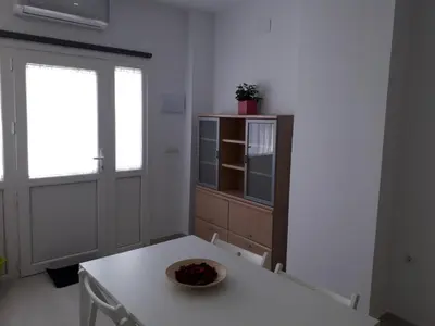 a kitchen with a table with a bowl of fruit on it at Apartamento faro Puerto Sherry in El Puerto de Santa María