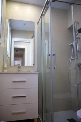 a bathroom with a shower and a sink and a mirror at LOS INFANTES 7-5-24 in Sanlúcar de Barrameda