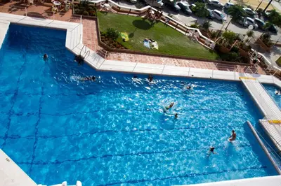 an overhead view of a large swimming pool with people in it at LOS INFANTES 7-5-24 in Sanlúcar de Barrameda