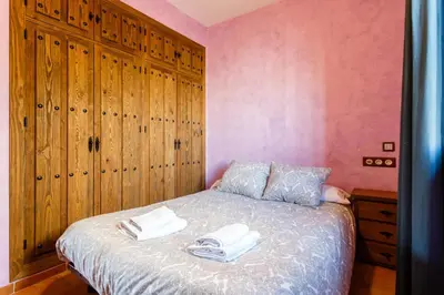a bedroom with a bed with two towels on it at El Castillito in Chiclana de la Frontera