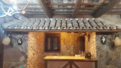 a stone building with a table and a roof at El Castillito in Chiclana de la Frontera
