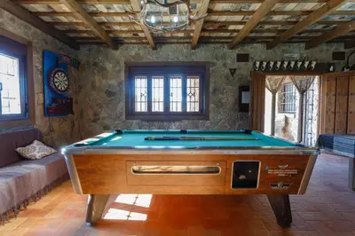 a pool table in the middle of a room at El Castillito in Chiclana de la Frontera