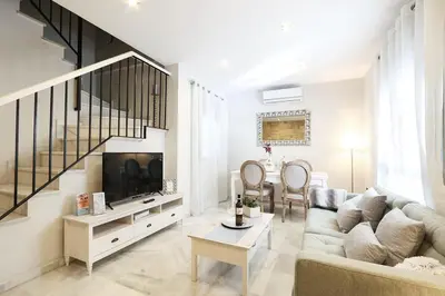 a living room with a couch and a tv at Little LIBERTAD Heart of Cadiz Grupo AC Gestion in Cádiz