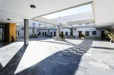 an empty courtyard of a building with a large window at Little LIBERTAD Heart of Cadiz Grupo AC Gestion in Cádiz
