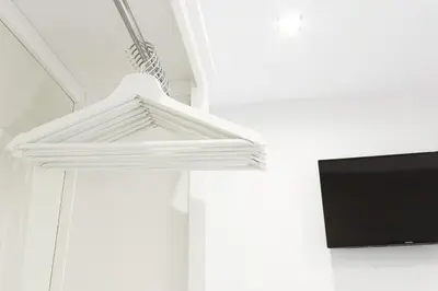 a white hanging light in a room with a tv at Little LIBERTAD Heart of Cadiz Grupo AC Gestion in Cádiz