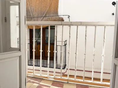 a balcony with a white railing and a window at Posada Flamenco Grupo AC Gestion in Cádiz