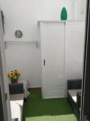 a room with a door and a green carpet at Apartamento Solis in Chipiona