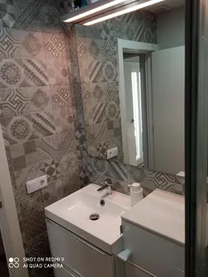 a bathroom with a sink and a mirror at Apartamento Solis in Chipiona
