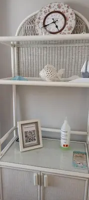 a shelf with a clock and a picture on it at Frente al mar in Rota