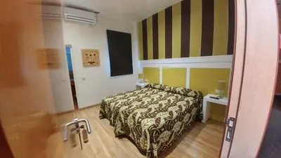 a hotel room with a bed and a mirror at Hostal Paris in San Fernando