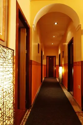 a hallway with orange walls and a long corridor at Hostal Paris in San Fernando