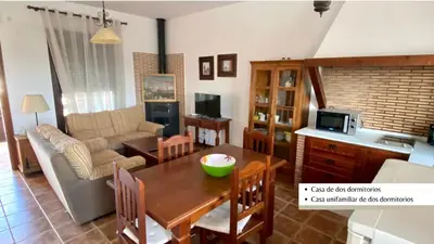 a living room with a table and a couch at Arco Casas Adosadas in Conil de la Frontera