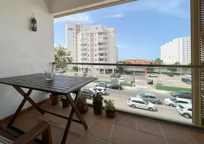a balcony with a table and a view of a parking lot at Apartamento en la playa de Valdelagrana in El Puerto de Santa María