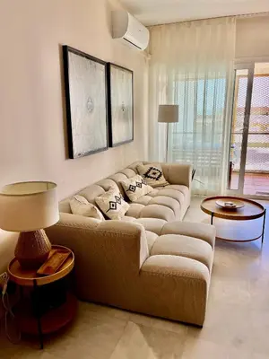 a living room with a couch and a table at Apartamento en la playa de Valdelagrana in El Puerto de Santa María