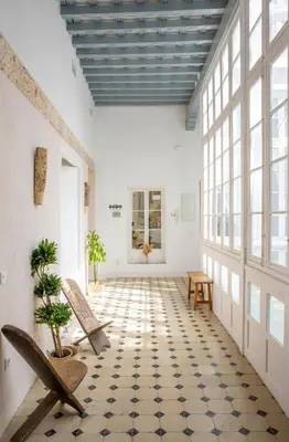 a room with two chairs and a tiled floor at Casa Plaza San Antonio in Cádiz