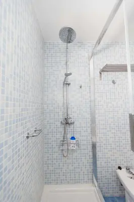 a bathroom with a shower with blue tiles at Atico Centro Historico in Cádiz