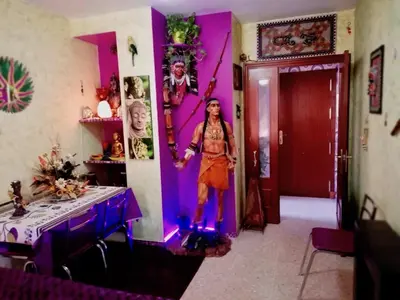 a woman standing in a room with purple walls at La Casita Del Indio in Sanlúcar de Barrameda