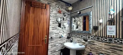 a bathroom with a sink and a mirror at La Casita Del Indio in Sanlúcar de Barrameda