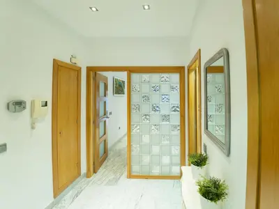 a hallway with doors and windows in a building at Apto Valdespino Gran Terraza fjhomefj in Jerez de la Frontera