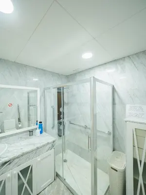 a white bathroom with a shower and a sink at Apto Valdespino Gran Terraza fjhomefj in Jerez de la Frontera