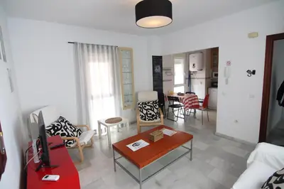 a living room with a couch and a table at Apartamento VELADOR del Sur by Cadiz4Rentals in Cádiz
