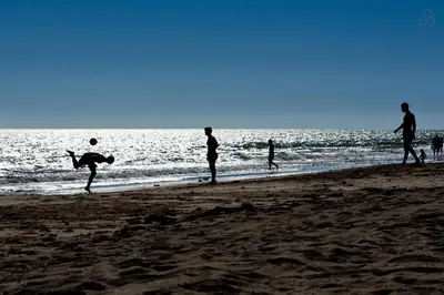 a group of people playing on the beach at APARTAMENTO VILLA DE ROTA - VISTA MAR, 135m2, Terraza, SAT TV y más in Rota