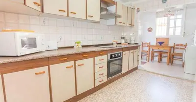 a kitchen with white appliances and a dining room at APARTAMENTO VILLA DE ROTA - VISTA MAR, 135m2, Terraza, SAT TV y más in Rota