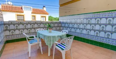 a table and chairs on the balcony of a house at APARTAMENTO VILLA DE ROTA - VISTA MAR, 135m2, Terraza, SAT TV y más in Rota