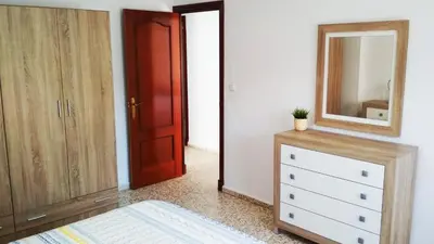a bedroom with a dresser and a mirror at APARTAMENTO VILLA DE ROTA - VISTA MAR, 135m2, Terraza, SAT TV y más in Rota
