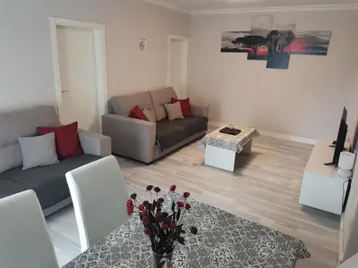 a living room with a couch and a table at Casasjerezanas Mariposa in Jerez de la Frontera