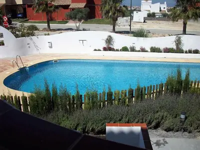 a large swimming pool with a fence around it at Cadiz Golf in Sanlúcar de Barrameda