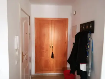 a hallway with a wooden door in a room at Cadiz Golf in Sanlúcar de Barrameda