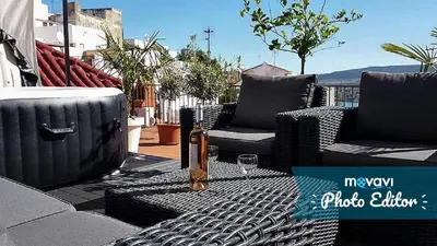 a patio with two chairs and a table with a wine glass at CASA RICARDO 