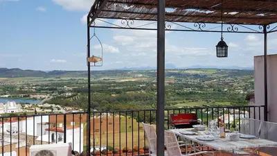 a table and chairs on a balcony with a view at CASA RICARDO 