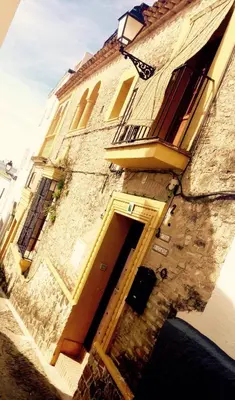 a stone building with a door and a balcony at CASA RICARDO 