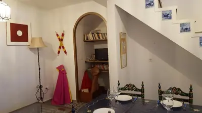 a dining room with a table and a staircase at CASA RICARDO 