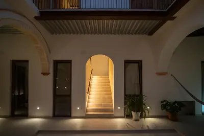 a hallway with a staircase in a building at Apartamentos Alcoba 13 in Sanlúcar de Barrameda