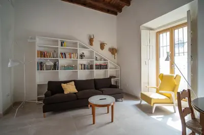 a living room with a couch and a table at Apartamentos Alcoba 13 in Sanlúcar de Barrameda