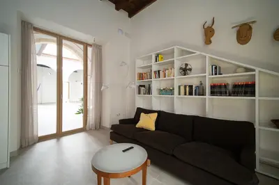 a living room with a couch and a table at Apartamentos Alcoba 13 in Sanlúcar de Barrameda