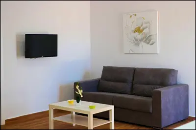 a living room with a couch and a table at Casa Rural Zara II in Conil de la Frontera