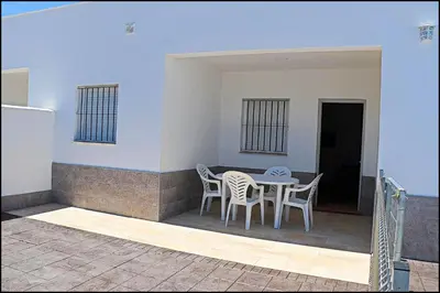 a patio with a table and chairs on a porch at Casa Rural Zara II in Conil de la Frontera
