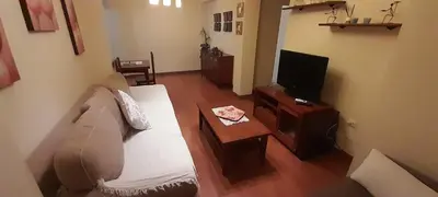 a living room with a couch and a tv at Emperador Carlos in San Fernando
