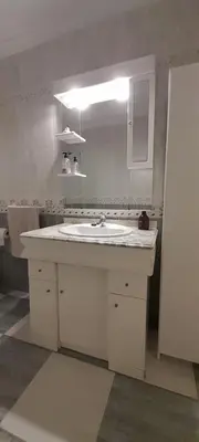 a kitchen with a white sink and a mirror at Emperador Carlos in San Fernando