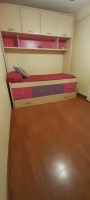 a room with a desk with pink cabinets and a wooden floor at Emperador Carlos in San Fernando